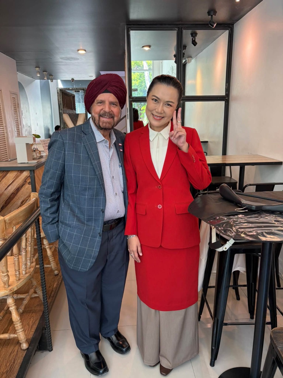 Frank with a customer in a red skirt suit