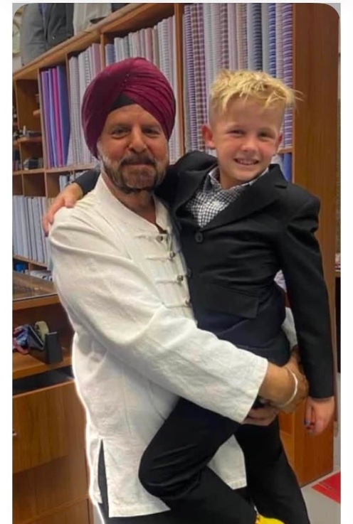 Frank holding a young boy in his new suit