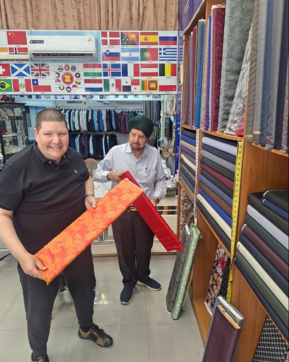 A customer choosing a red silk cloth