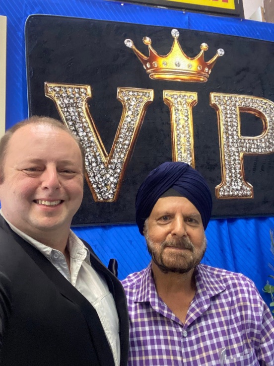 A customer with Frank at the VIP wall